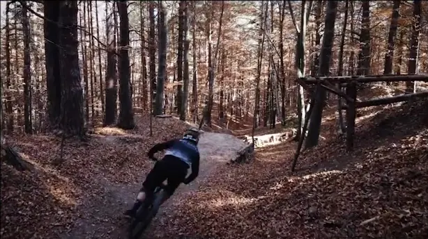The rider on a berm through the trees